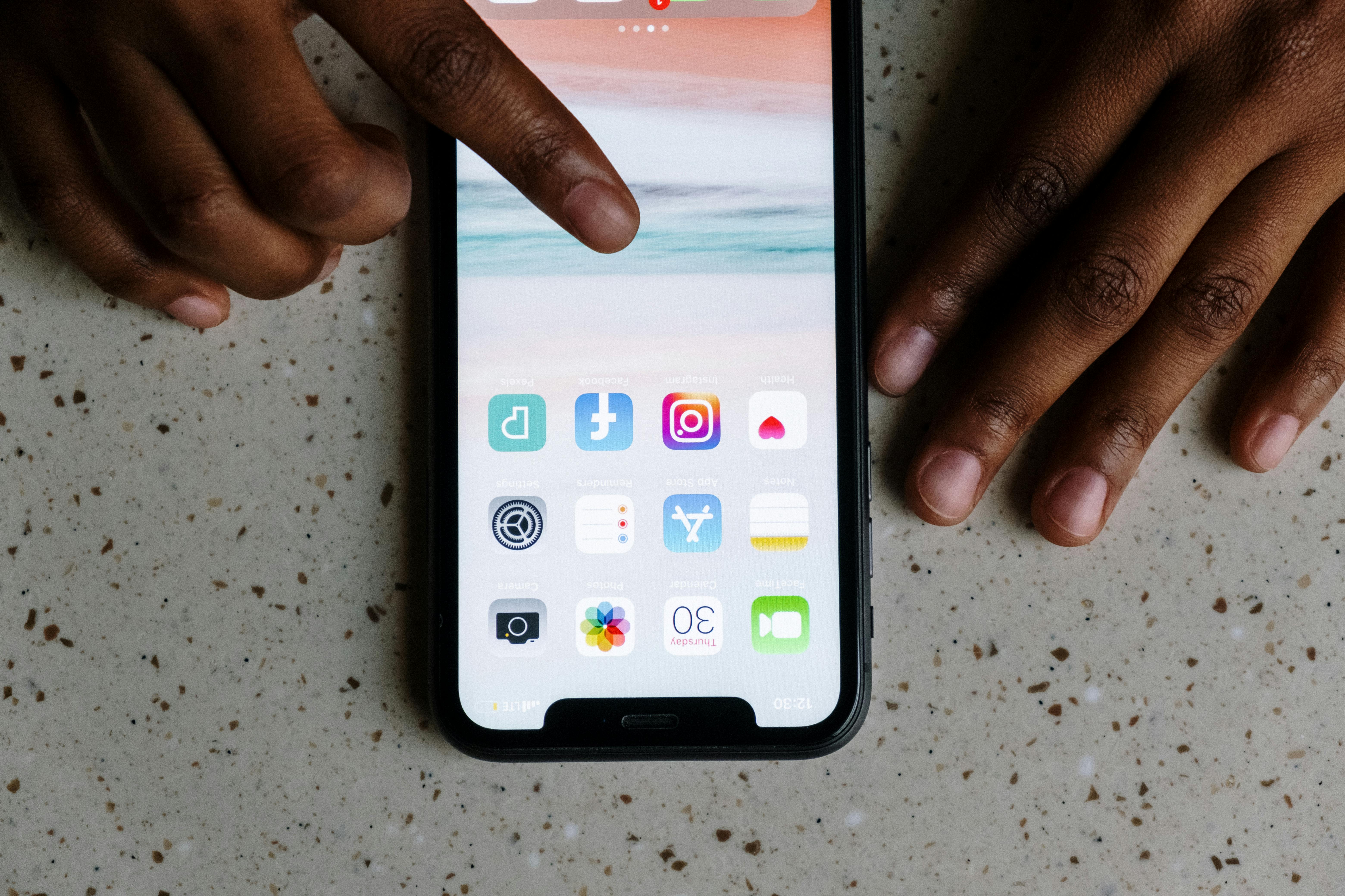 Person holding smartphone with Instagram feed open