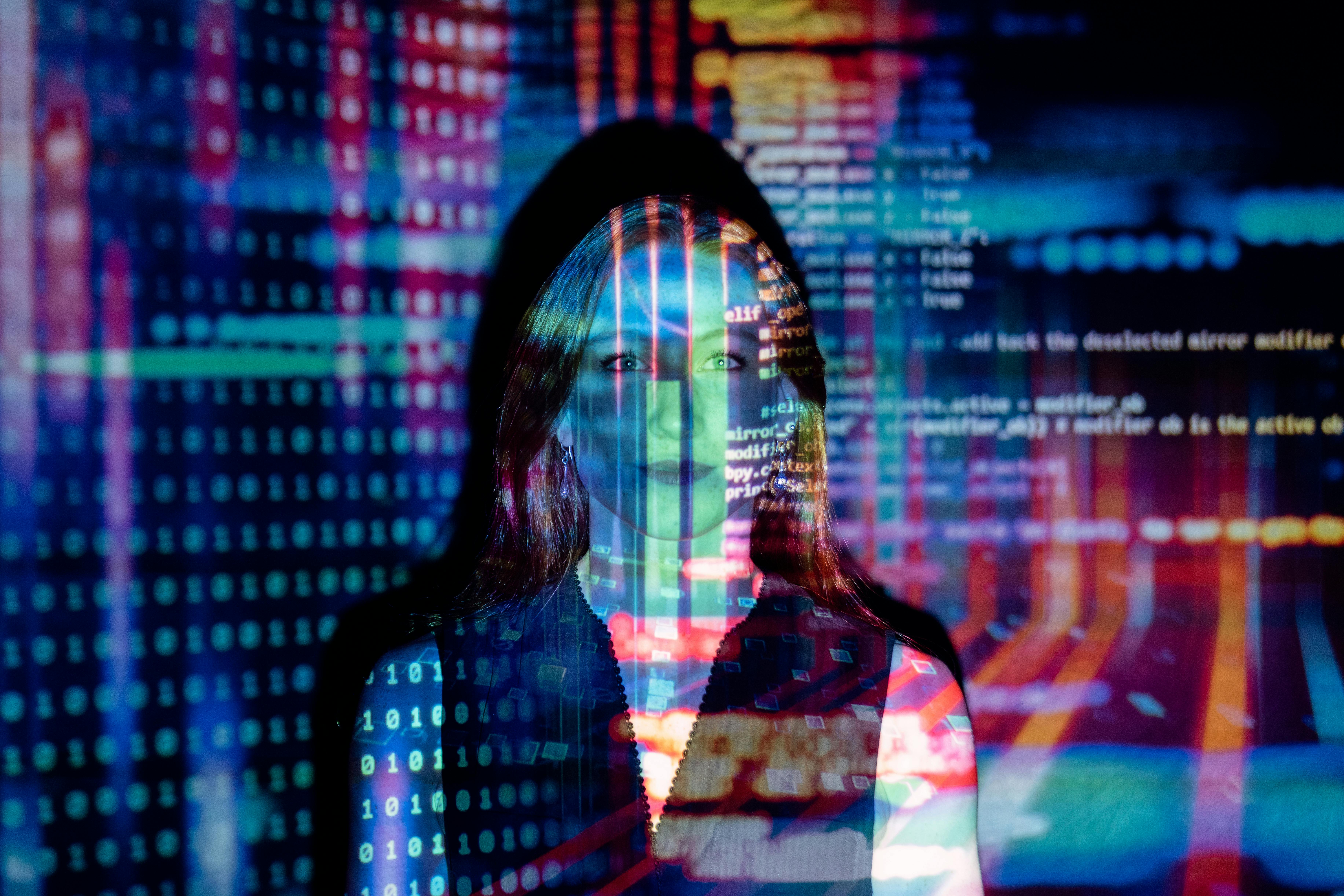 Dual monitors displaying code and analytics in a dark office